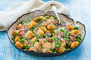 Potato gnocchi with green peas, pesto, proscuitto and chorizo