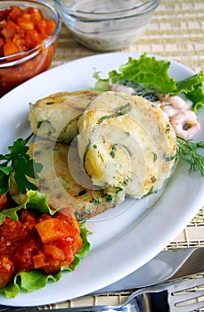 Potato and greens cakes with two sauces