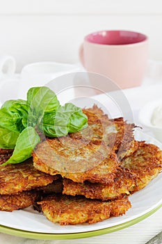 Potato pancakes and cup of milk