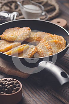 Potato pancakes in a frying pan.