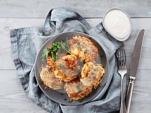 Potato pancakes on gray tabletop, top view