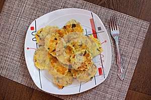 Potato pancakes with green onions. Draniki - potato fritters. The naitonal dish of Belarus, Ukraine and Russia. Potato zucchini