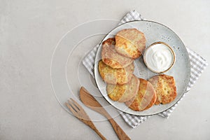 Potato pancakes or latkes or draniki with sour cream in plate