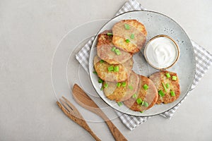 Potato pancakes or latkes or draniki with sour cream in plate