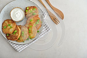 Potato pancakes or latkes or draniki with sour cream in plate