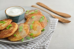 Potato pancakes or latkes or draniki with sour cream in plate