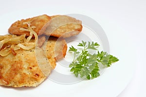 Potato pancakes or latkes or draniki on white plate. Top view. Copy space. Fried potato pancakes