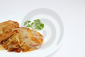 Potato pancakes or latkes or draniki on white plate. Top view. Copy space. Fried potato pancakes