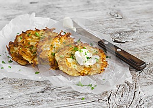 Potato pancakes or latkes on a light rustic wood surface