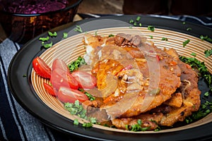 Potato pancakes with meat stew served on a plate