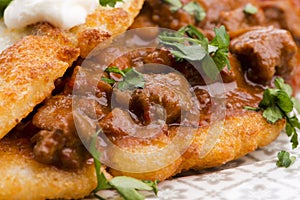 Potato pancakes with meat, vegetable, tomato and parsley