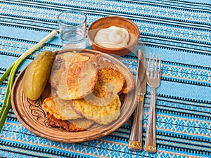 Potato pancakes (potato flapjacks) and a glass of vodka