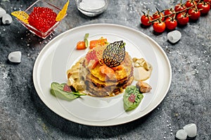 Potato pancakes with red caviar, red fish and mushroom sauce. banner, menu, recipe place for text, top view