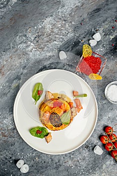 Potato pancakes with red caviar, red fish and mushroom sauce. banner, menu, recipe place for text, top view