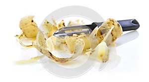 Potato peelings with peeler photo
