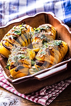 Potato.Roasts potatoes. Home cooking roasts potatoes. Baking pan full of baked potatoes stuffed with bacon sausage onions