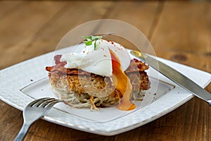 Potato rosti, poached egg with runy yolk and bacon on top.