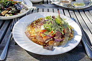 Potato rosti on a white plate.