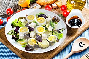 Potato salad with chicken eggs, leaves oakleaf lettuce, cheese,