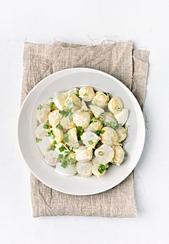 Potato salad with eggs and green onion