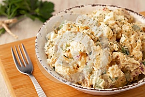 Potato Salad In Rustic Bowl On Wood Cutting Board