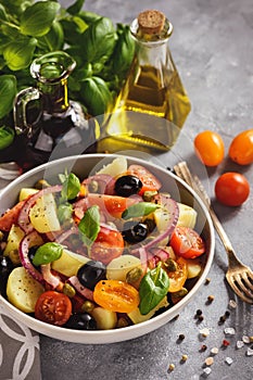 Potato salad with tomatoes, olives, capers, red onion, italian style cuisine. Insalata Pantesca.