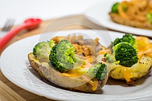 Potato Skins appetizer with broccoli, cheddar cheese and fried onions