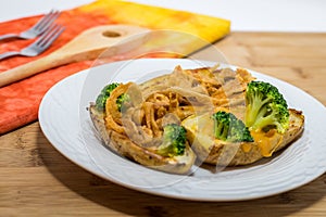 Potato Skins appetizer with broccoli, cheddar cheese and fried onions