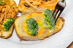 Potato Skins appetizer with broccoli, cheddar cheese and fried onions