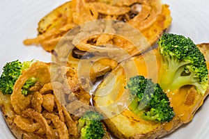 Potato Skins appetizer closeup with broccoli, cheddar cheese and fried onions