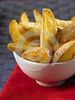 Potato wedges in a white bowl