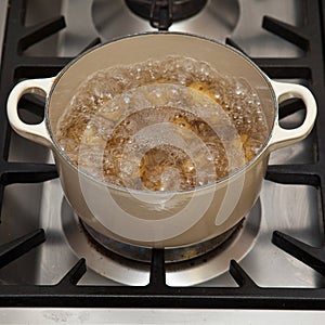 Potatoes boiling in pot