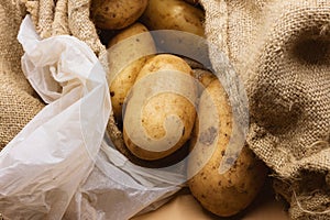 Potatoes, Burlap jute sack and a plastic bag. Market scene