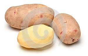 Potatoes close-up, raw and peeled, objects are isolated on a white background