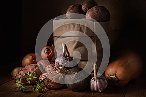 Potatoes in a cloth bag and other vegetables