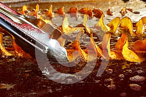 Potatoes are fried in boiling oil