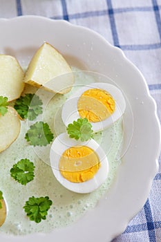 Potatoes with green sauce and eggs
