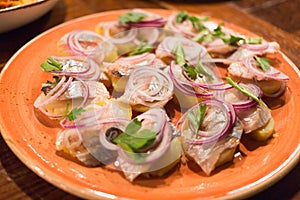 potatoes with herring onion and greens on a