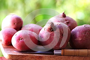 potatoes and knife on wooden table