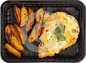 Potatoes with meat in a disposable rectangular plastic black lunch box top view on a white background