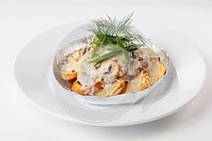Potatoes with mushrooms in foil isolated white background mayonnaise cheese