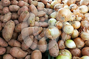 Potatoes and onions on counter of the store