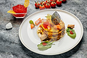Potatoes pancakes fried with red caviar, red fish and mushroom sauce. banner, menu, recipe place for text, top view