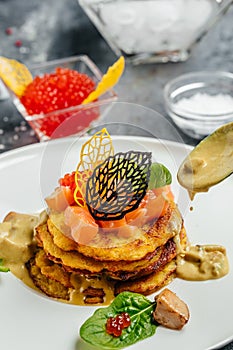 Potatoes pancakes fried with red caviar, red fish and mushroom sauce. banner, menu, recipe place for text, top view