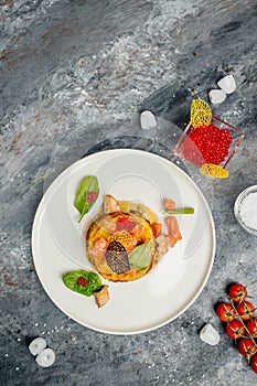 Potatoes pancakes fried with red caviar, red fish and mushroom sauce. vertical image. top view. place for text