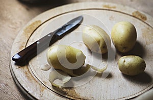 Potatoes peeled on a cutting board