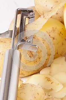 Potatoes with Peeler and Peeled Skin