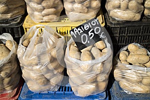 Potatoes in plastic bags on a Greek market stall