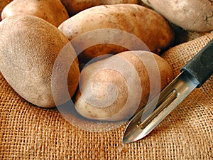 Potatoes and potatoe peeler