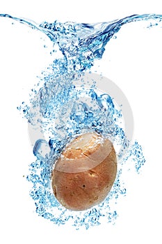 Potatoes splashing in water